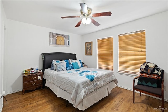 bedroom with ceiling fan and hardwood / wood-style floors