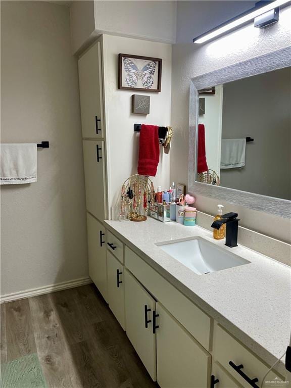 bathroom featuring vanity and hardwood / wood-style floors