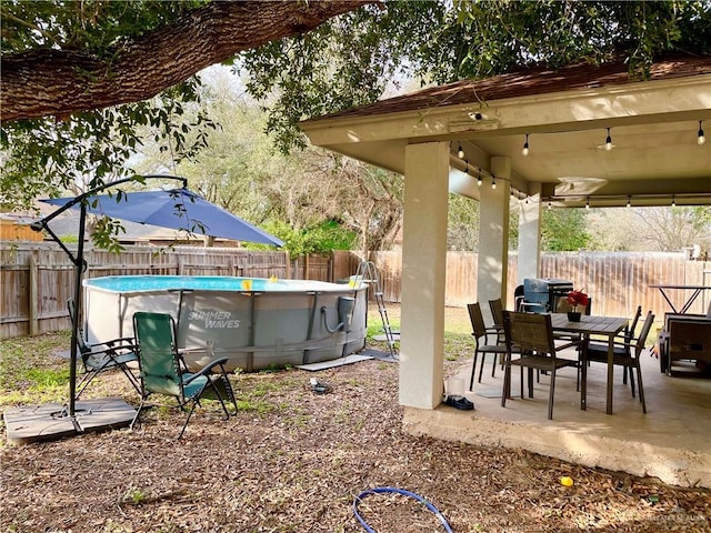 view of yard featuring a fenced in pool and a patio area