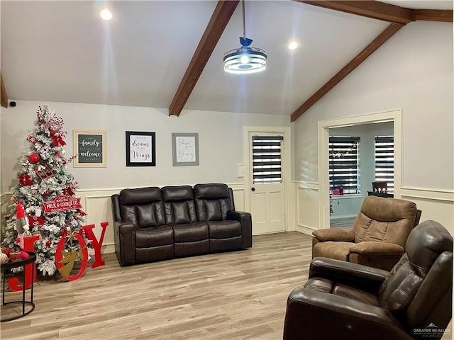 living room with lofted ceiling with beams and light hardwood / wood-style floors