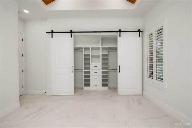 1313 Oriole Ave, Mcallen, TX 78504 - unfurnished bedroom with a barn door, baseboards, and marble finish floor