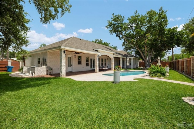 1313 Oriole Ave, Mcallen, TX 78504 - rear view of property featuring a fenced in pool, a fenced backyard, a patio area, a lawn, and a ceiling fan