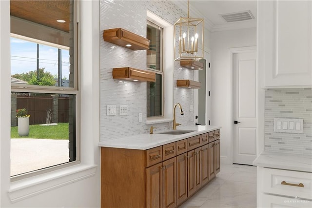 1313 Oriole Ave, Mcallen, TX 78504 - bar with visible vents, crown molding, decorative backsplash, and a sink