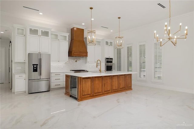 1313 Oriole Ave, Mcallen, TX 78504 - kitchen featuring premium range hood, marble finish floor, an inviting chandelier, and appliances with stainless steel finishes