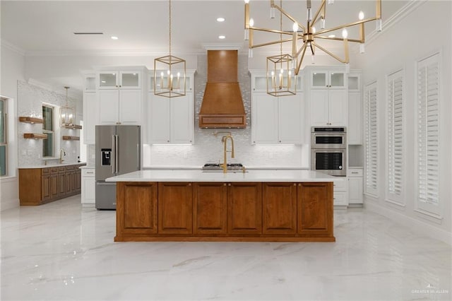 1313 Oriole Ave, Mcallen, TX 78504 - kitchen featuring crown molding, appliances with stainless steel finishes, custom exhaust hood, and an inviting chandelier