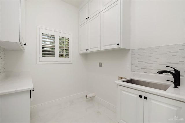 1313 Oriole Ave, Mcallen, TX 78504 - laundry area with a sink, hookup for an electric dryer, marble finish floor, cabinet space, and baseboards