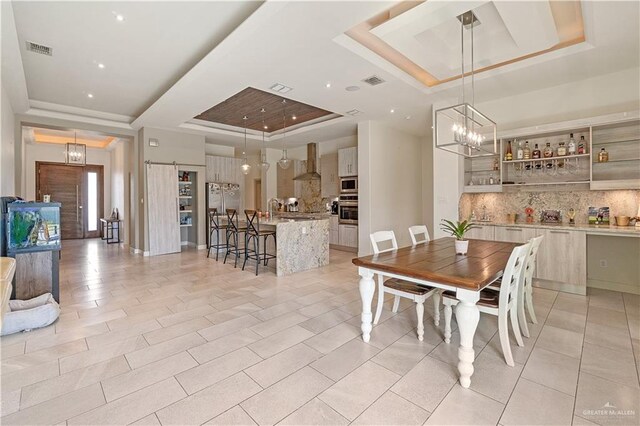 2520 Colvin Ave, Edinburg, TX 78539 - tiled dining space with a raised ceiling, sink, and a notable chandelier