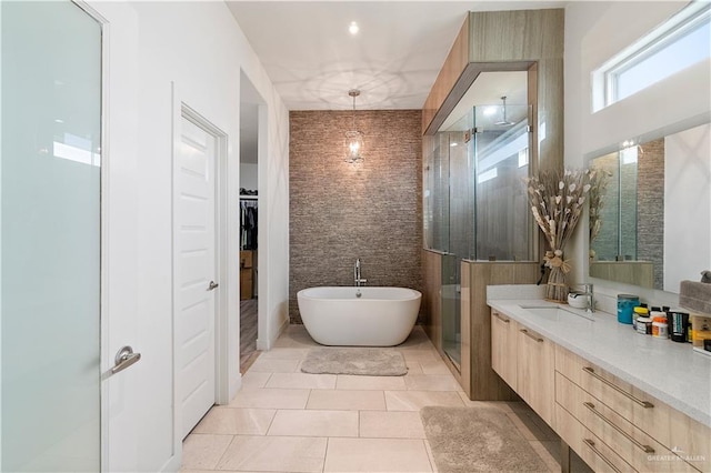 2520 Colvin Ave, Edinburg, TX 78539 - bathroom with tile patterned flooring, shower with separate bathtub, vanity, and tile walls