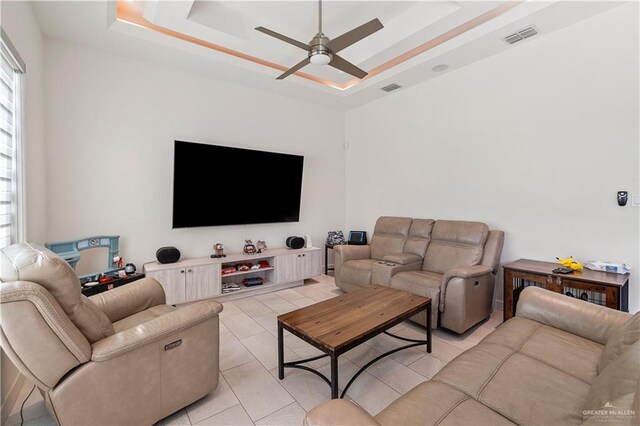 2520 Colvin Ave, Edinburg, TX 78539 - living room featuring light tile patterned floors, a tray ceiling, a wealth of natural light, and ceiling fan