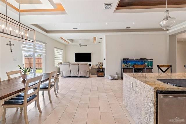 2520 Colvin Ave, Edinburg, TX 78539 - dining room with ceiling fan with notable chandelier and a tray ceiling
