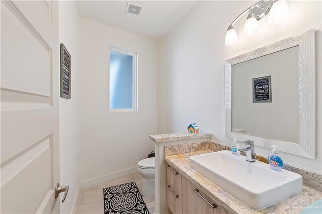 2520 Colvin Ave, Edinburg, TX 78539 - bathroom featuring tile patterned floors, vanity, and toilet