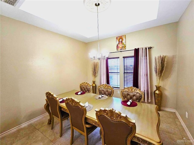 dining room with a chandelier and tile patterned floors