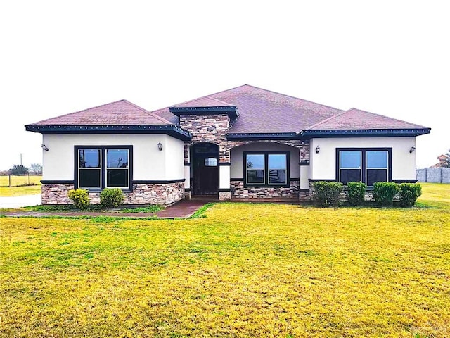 rear view of house featuring a lawn