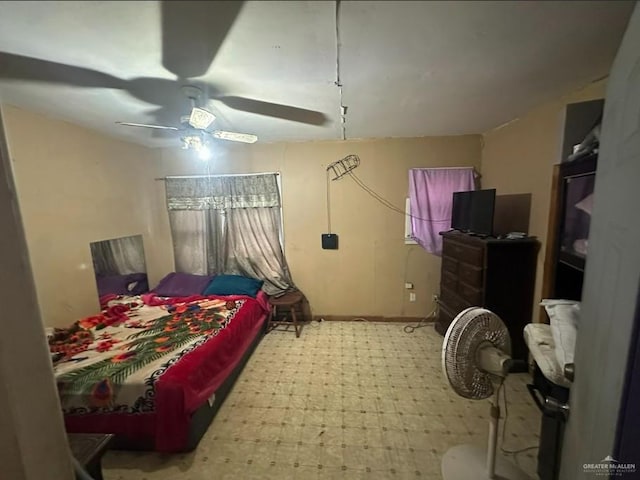 bedroom with tile patterned floors and ceiling fan