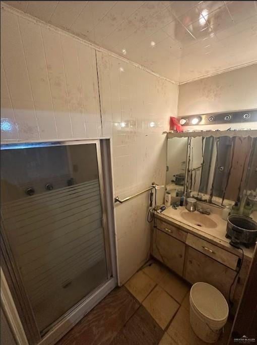 bathroom featuring tile patterned floors, vanity, and a stall shower