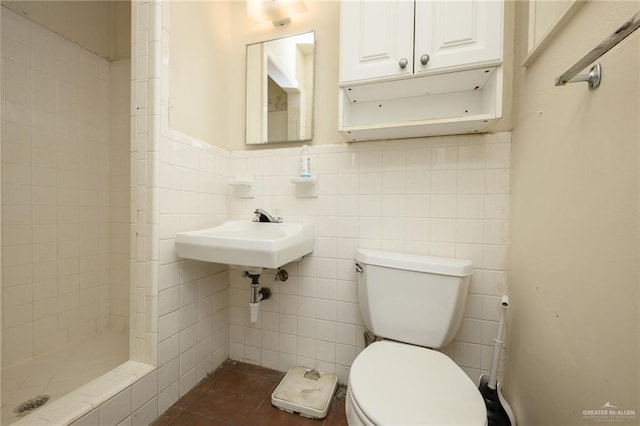 2805 N Blake St, Harlingen, TX 78550 - bathroom featuring a shower stall, tile walls, and tile patterned floors
