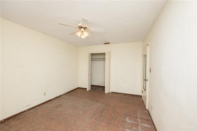 2805 N Blake St, Harlingen, TX 78550 - unfurnished bedroom with a textured ceiling, a ceiling fan, a closet, and tile patterned floors