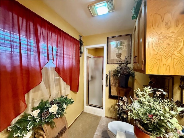 2312 Yarrow St, Mission, TX 78574 - full bath featuring a shower stall, toilet, tile patterned flooring, and baseboards