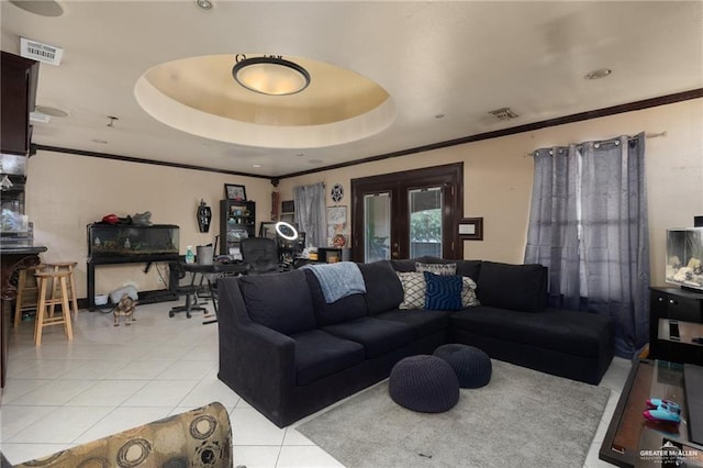 living room with french doors, a tray ceiling, and light tile patterned flooring