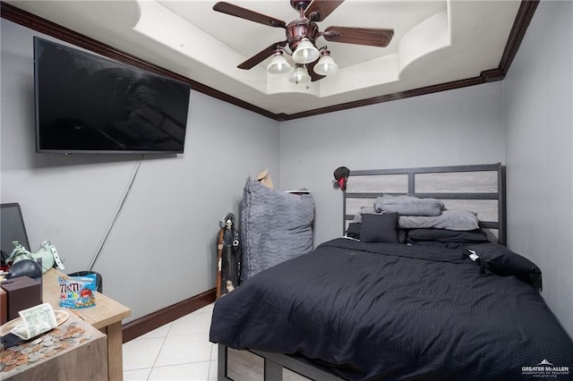 bedroom featuring ceiling fan, light tile patterned flooring, crown molding, and a tray ceiling