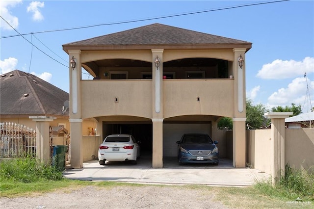 view of front of house with a balcony and a carport