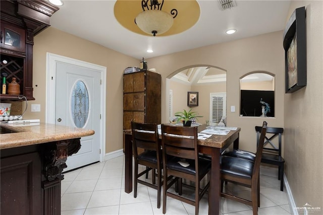 tiled dining area featuring beamed ceiling and coffered ceiling