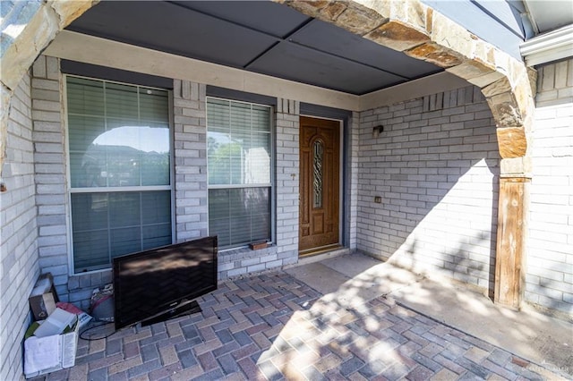 entrance to property with brick siding