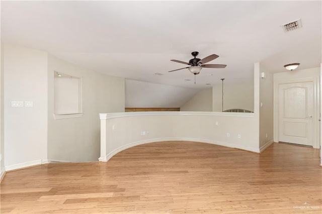 unfurnished room with ceiling fan, light hardwood / wood-style flooring, and lofted ceiling