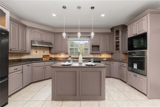 kitchen featuring black appliances, a center island, and gray cabinets