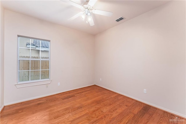 empty room with hardwood / wood-style flooring and ceiling fan