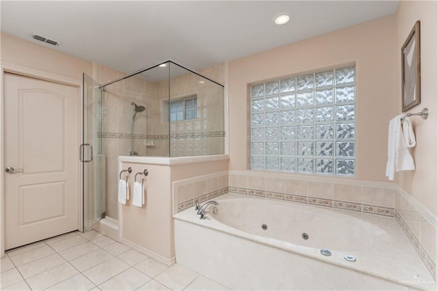 bathroom featuring tile patterned floors and separate shower and tub