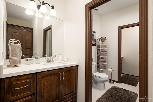 bathroom with tile patterned floors, vanity, and toilet