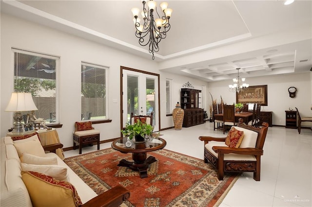 sitting room with a notable chandelier, a healthy amount of sunlight, light tile patterned floors, and french doors