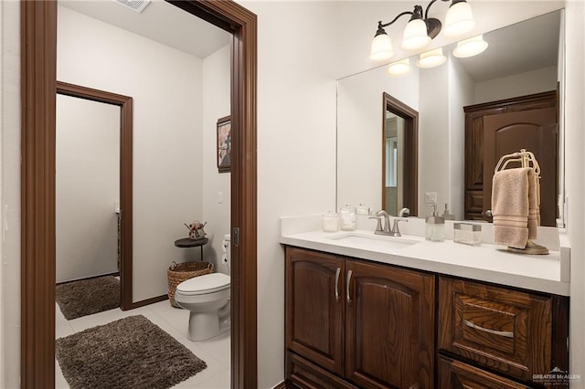 bathroom featuring tile patterned floors, vanity, and toilet