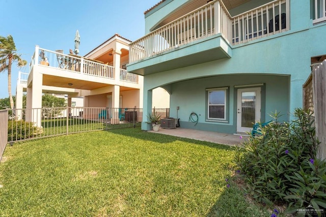 rear view of house featuring a patio area and a yard