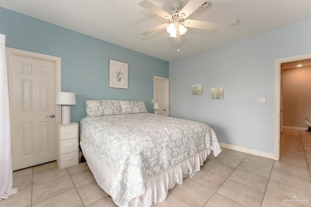 tiled bedroom featuring ceiling fan