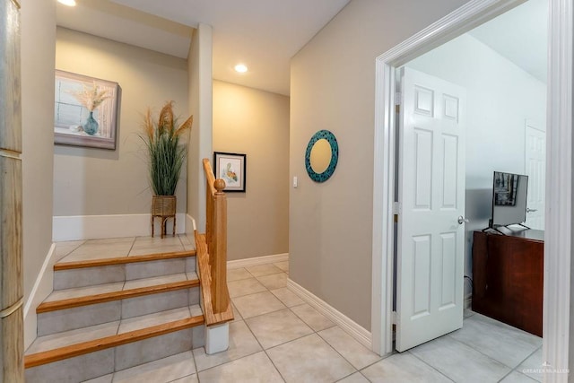 hall featuring light tile patterned floors