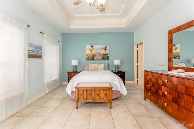 tiled bedroom featuring a tray ceiling and ceiling fan