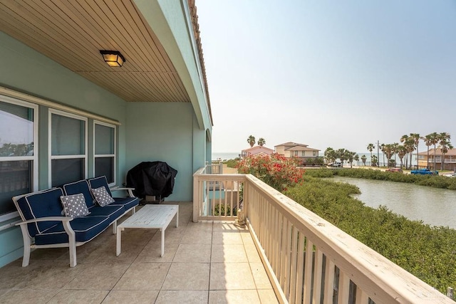 balcony with a grill and a water view