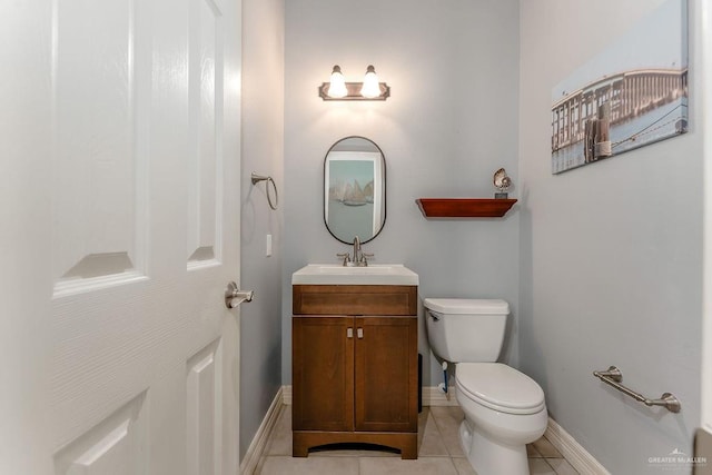 bathroom with tile patterned flooring, vanity, and toilet