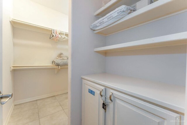 spacious closet with light tile patterned floors