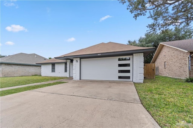 view of front of property with a front yard and a garage