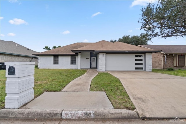 ranch-style home featuring a front lawn and a garage