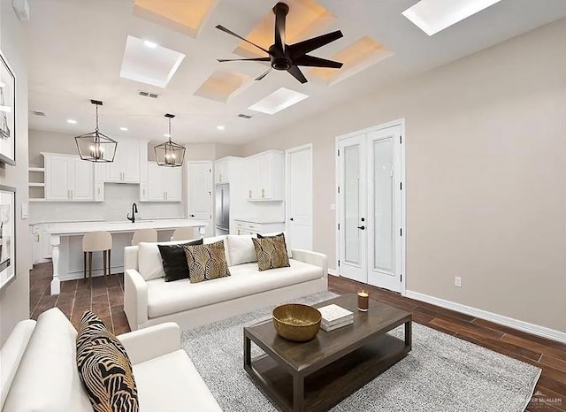 living room with recessed lighting, dark wood-type flooring, a ceiling fan, coffered ceiling, and baseboards