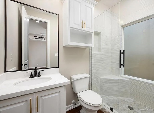 full bath featuring a ceiling fan, a shower stall, vanity, and toilet