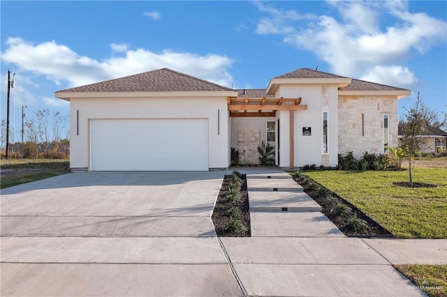 view of front of house with an attached garage, concrete driveway, stone siding, stucco siding, and a front lawn