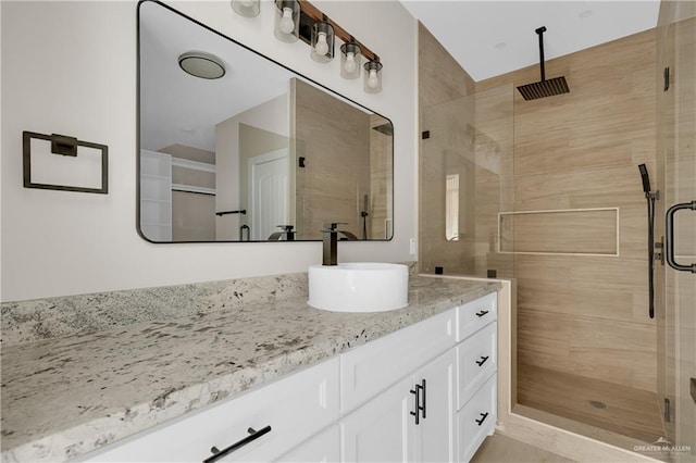 full bath featuring a shower stall and vanity