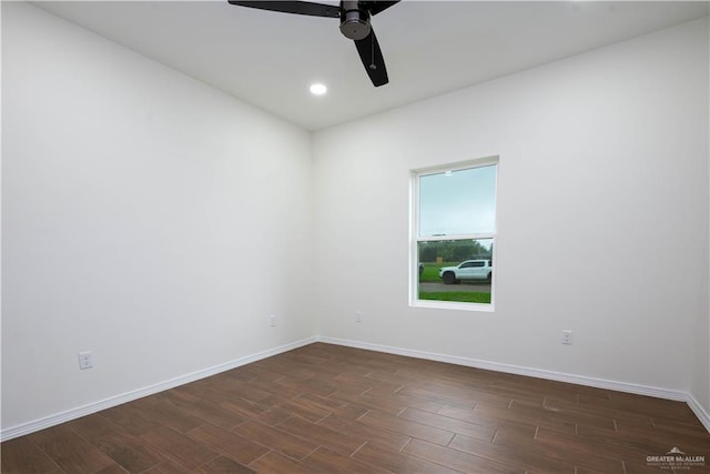 spare room featuring dark hardwood / wood-style floors and ceiling fan