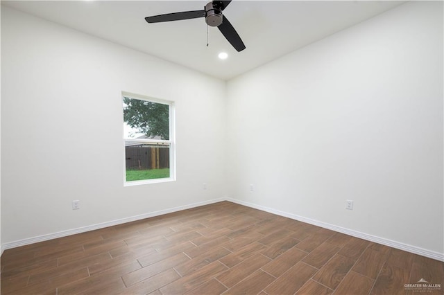 spare room with ceiling fan and dark hardwood / wood-style flooring