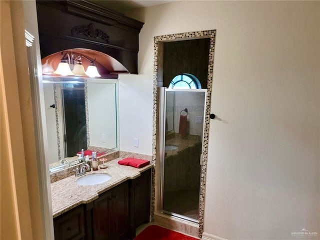 bathroom with a shower stall and vanity